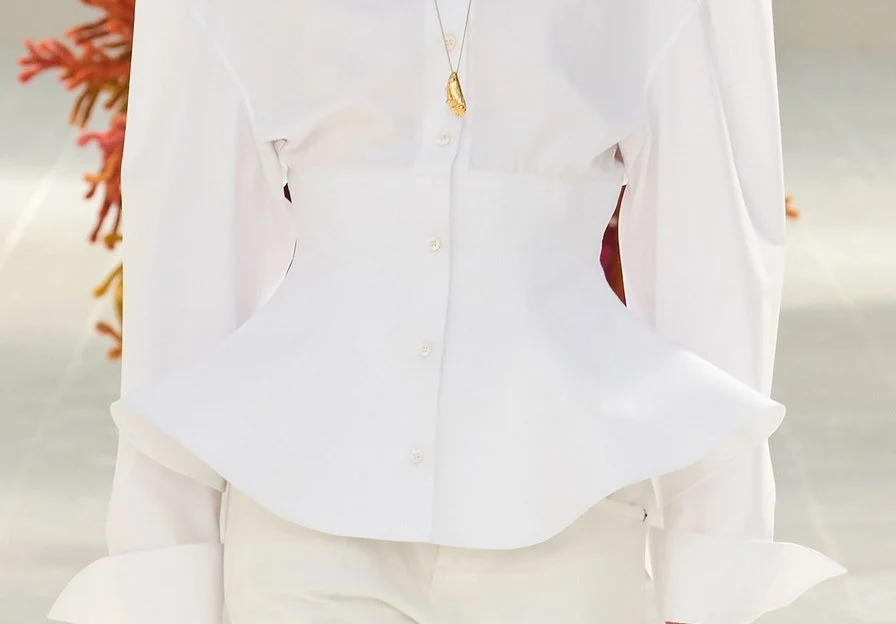 Closer: rows of stitching pull the shirt in at the waist and flare it out below.