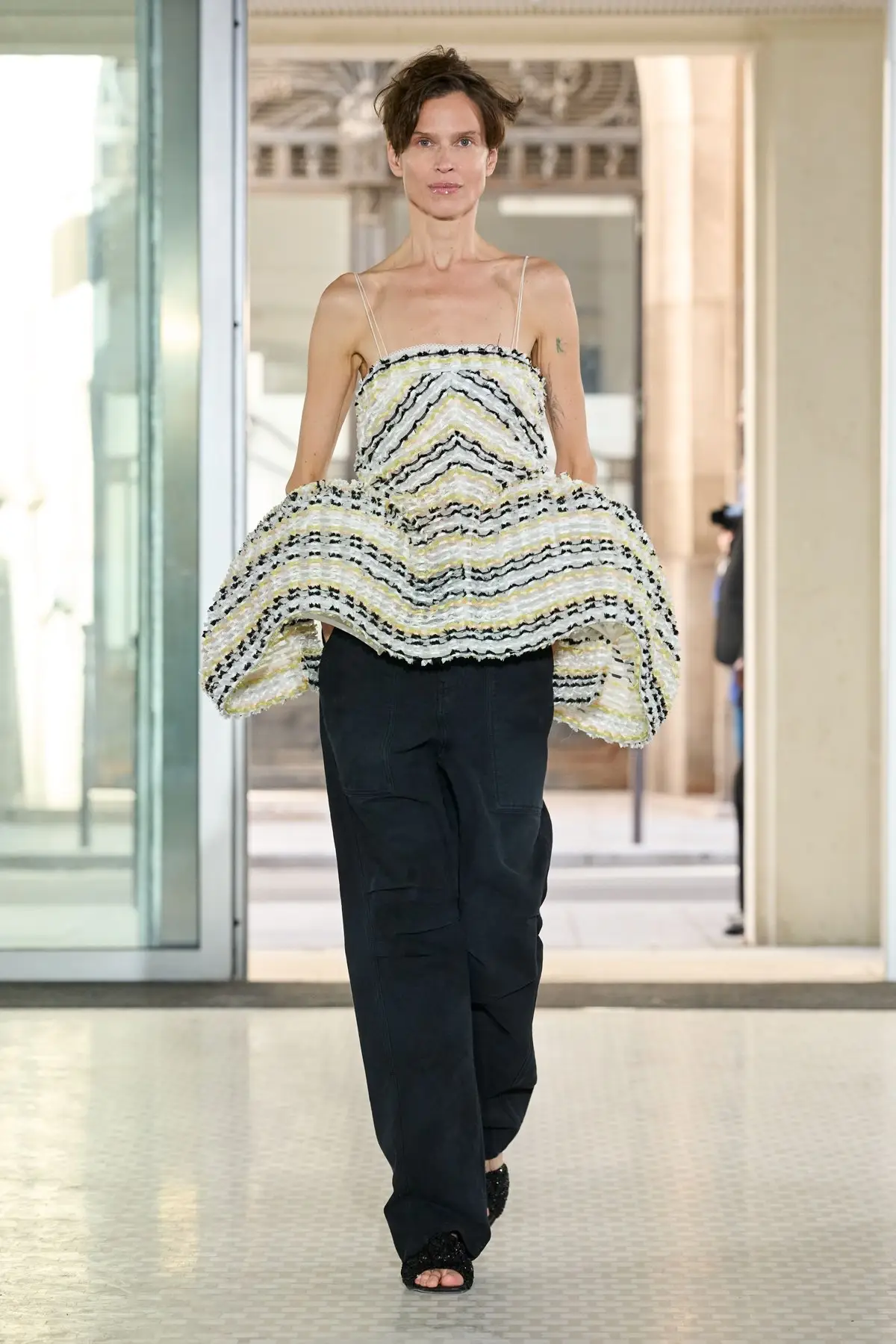 Cecilie Bahnsen, Look 9. A striped pannier top over dark trousers.