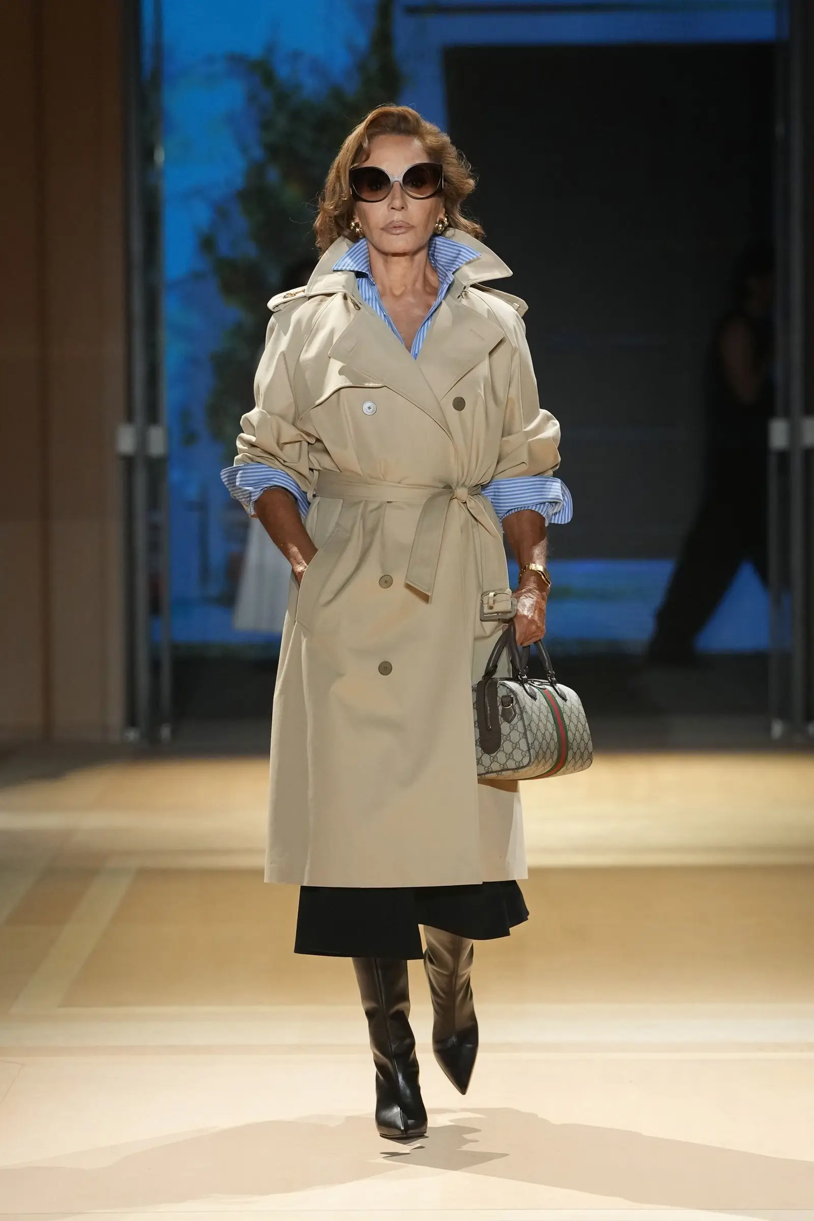 Gucci SS27, Look 10. Naty Abascal in a beige trench.