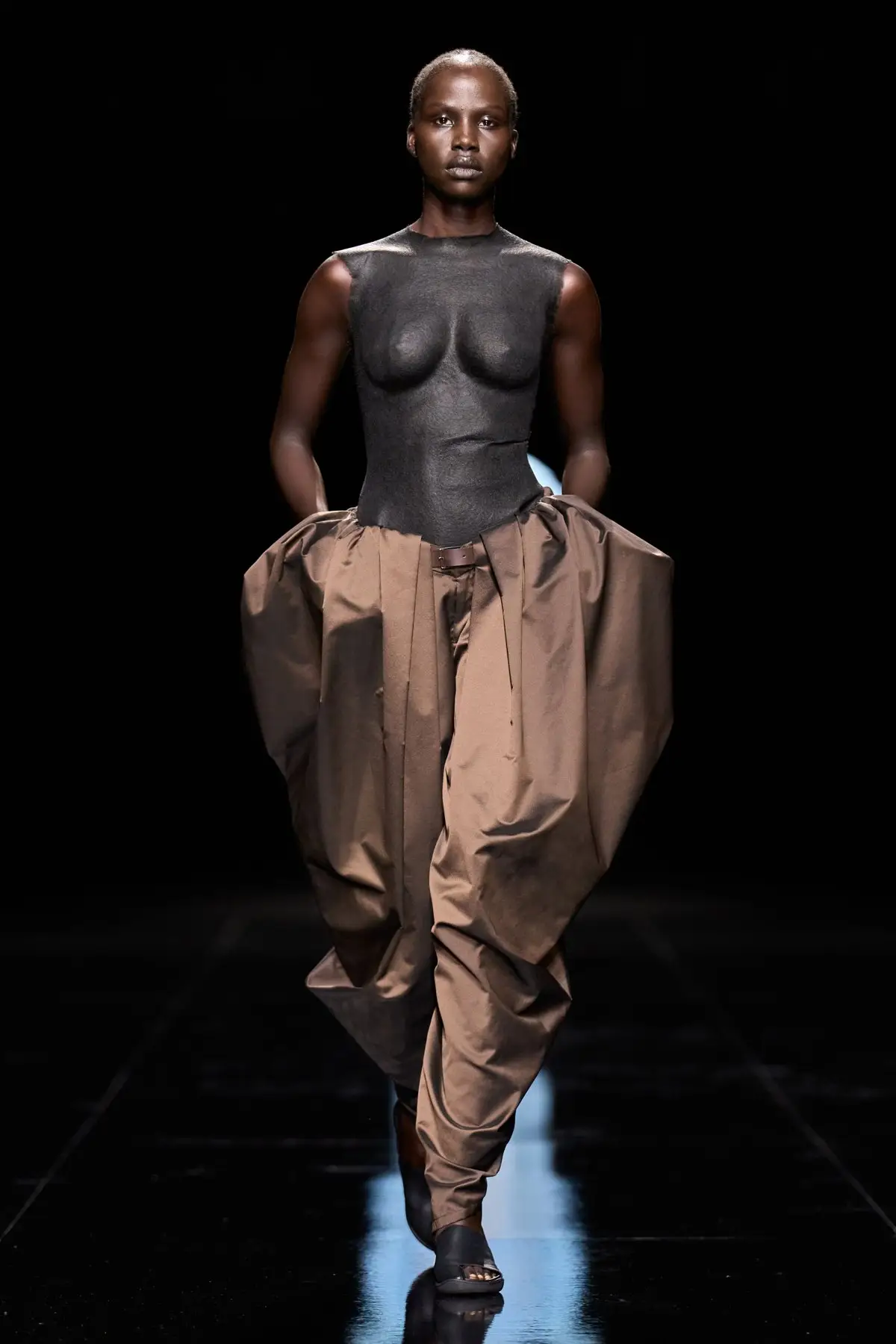 Look 28. The same moulded idea in black.