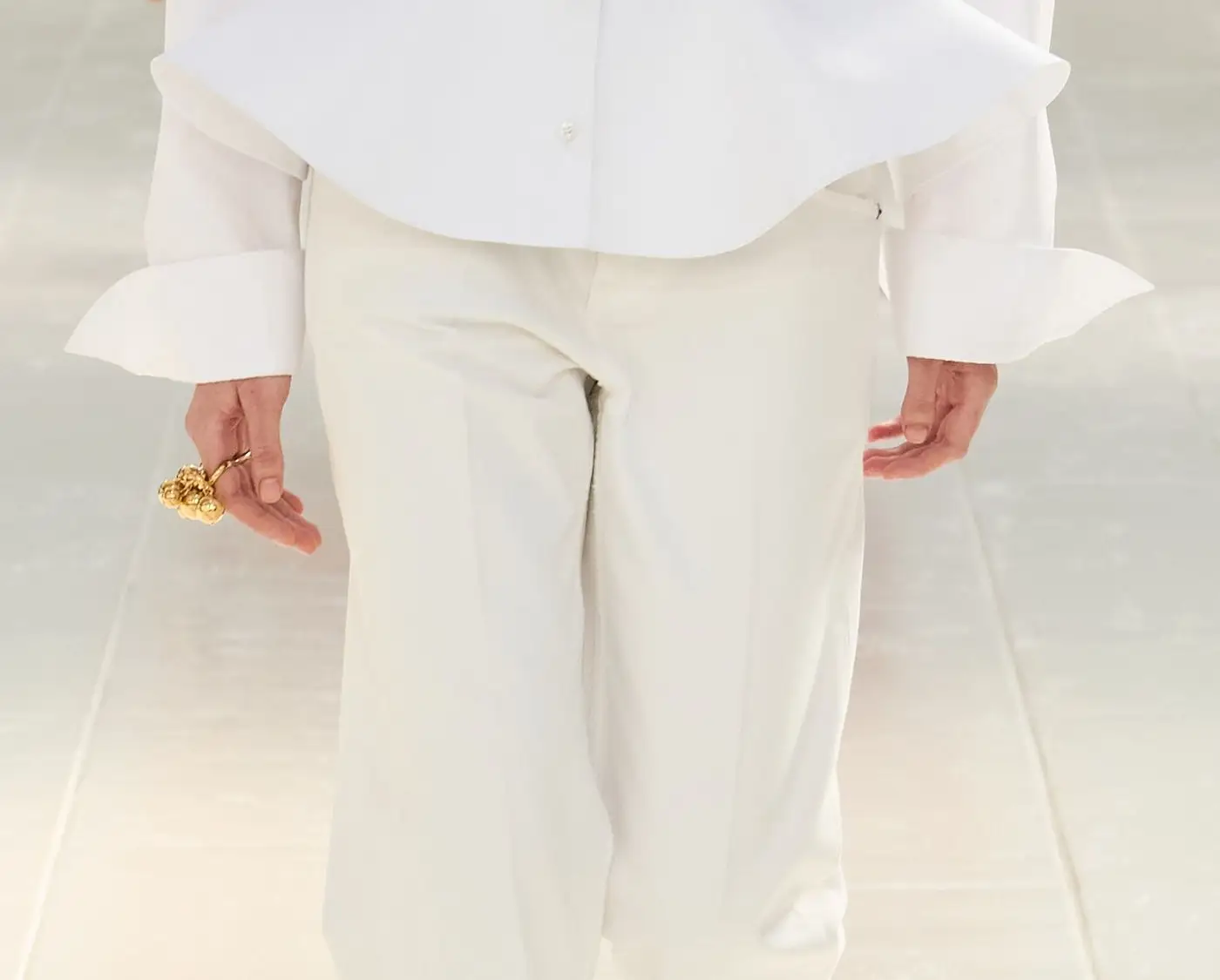 Balenciaga SS27, Look 1, closer. The white shirt flares into a peplum below a stitched waist.