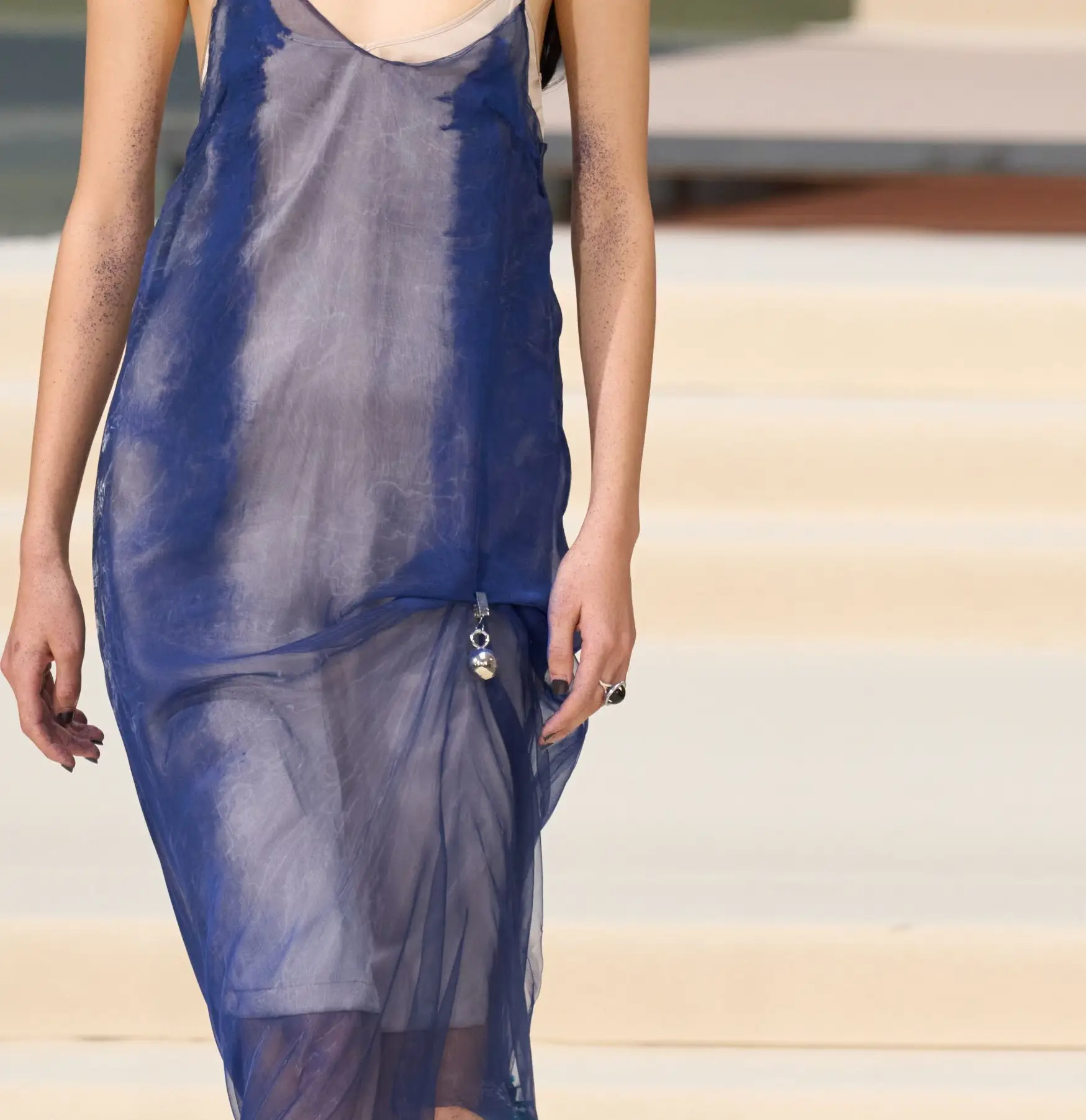 Julie Kegels SS27, Look 17, closer. Sheer organza pulled into diagonal folds towards a clip at the hip.