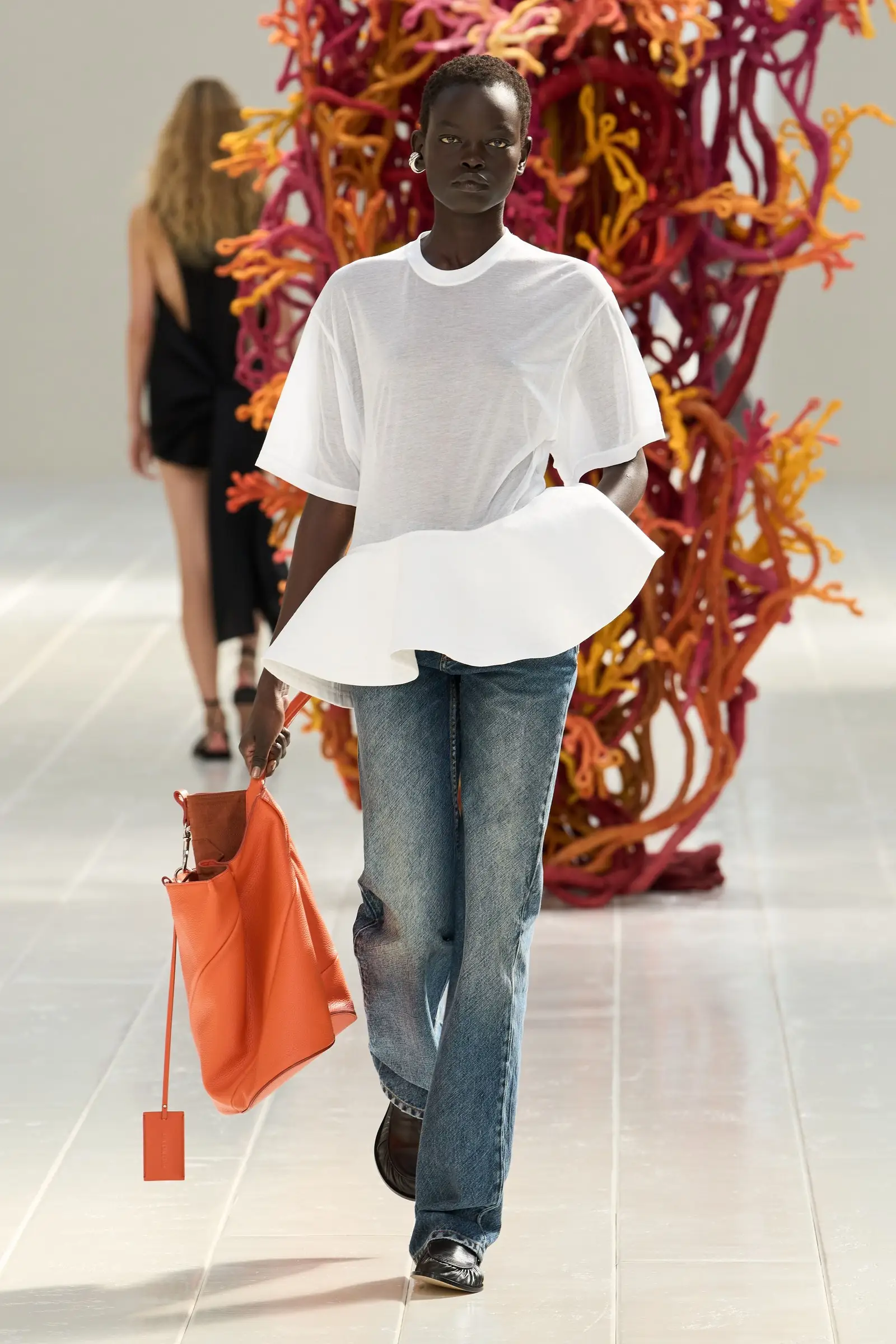 Look 35. White short-sleeve crew T-shirt with the same stitched peplum, over blue jeans.