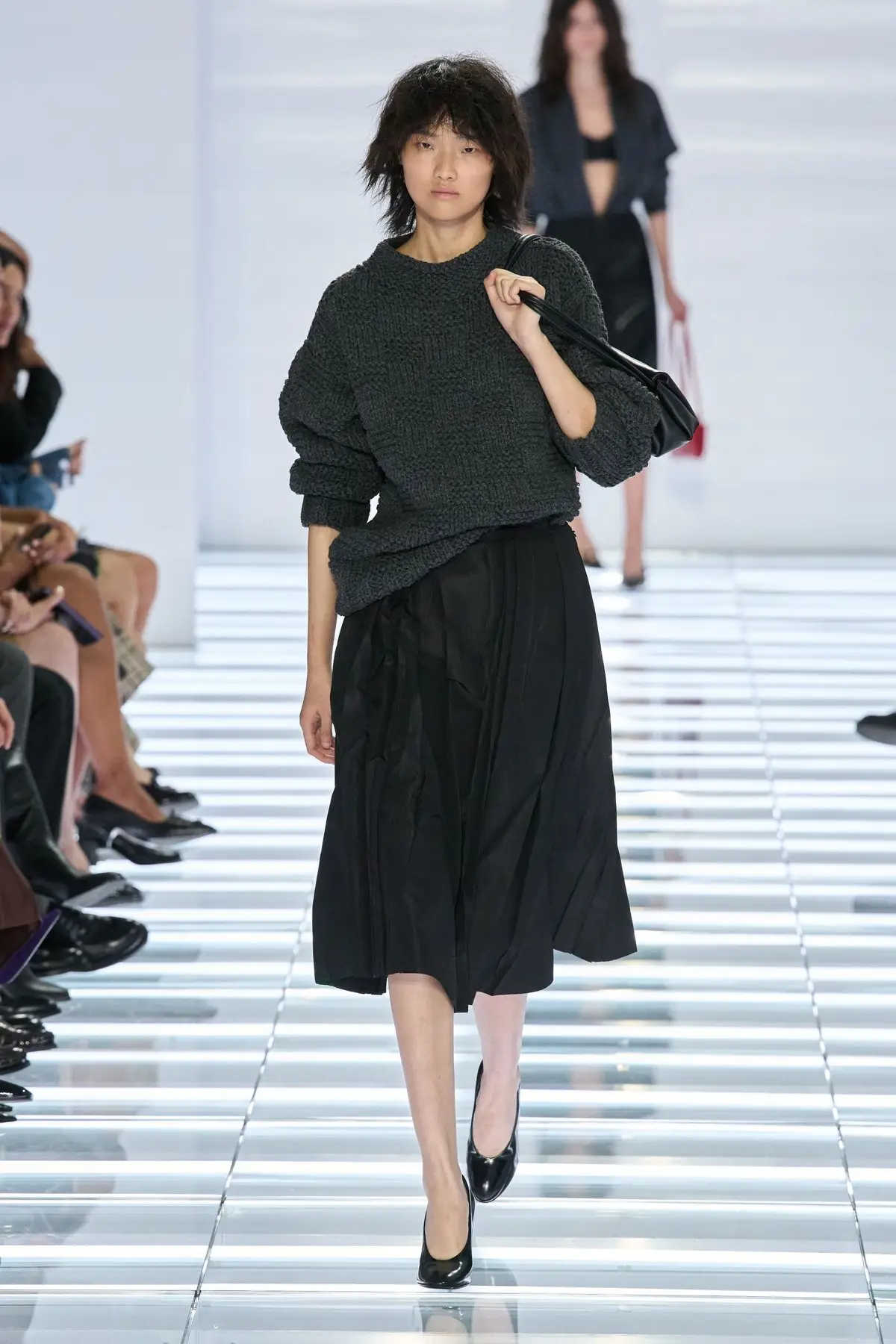 Look 42. Black skirt under a dark sweater.