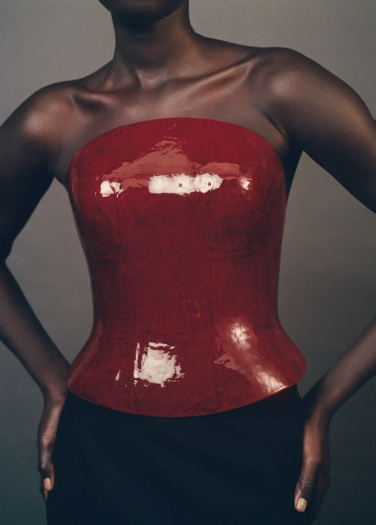 Issey Miyake AW26/27, Urushi Body. Dark red lacquered shell worn as a bustier.