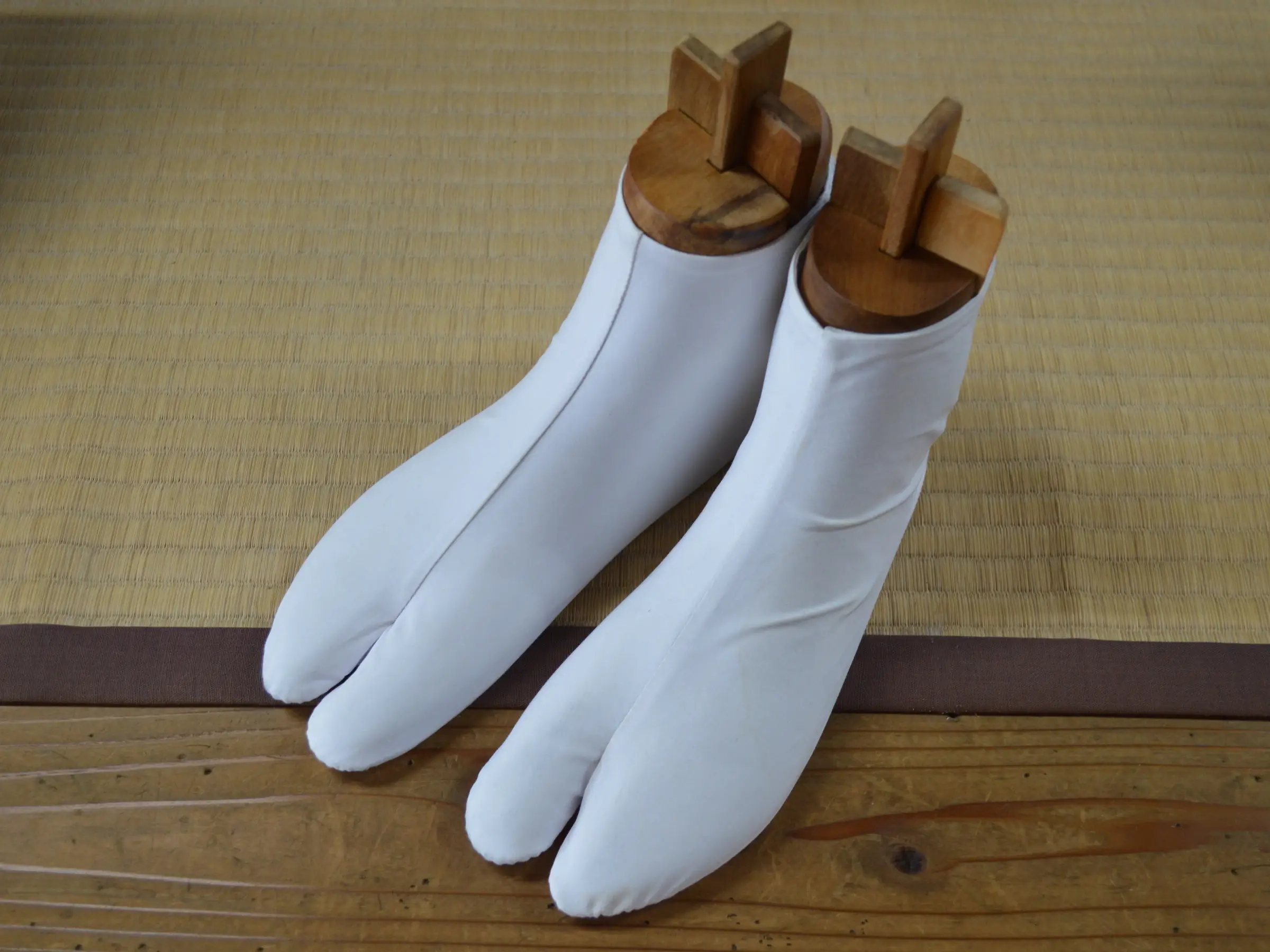 White tabi socks on wooden lasts at the Tabi and Living Museum in Gyoda, Japan. The big toe has its own pocket.